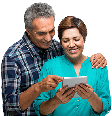 An elder man and women smiling while looking at iPad
